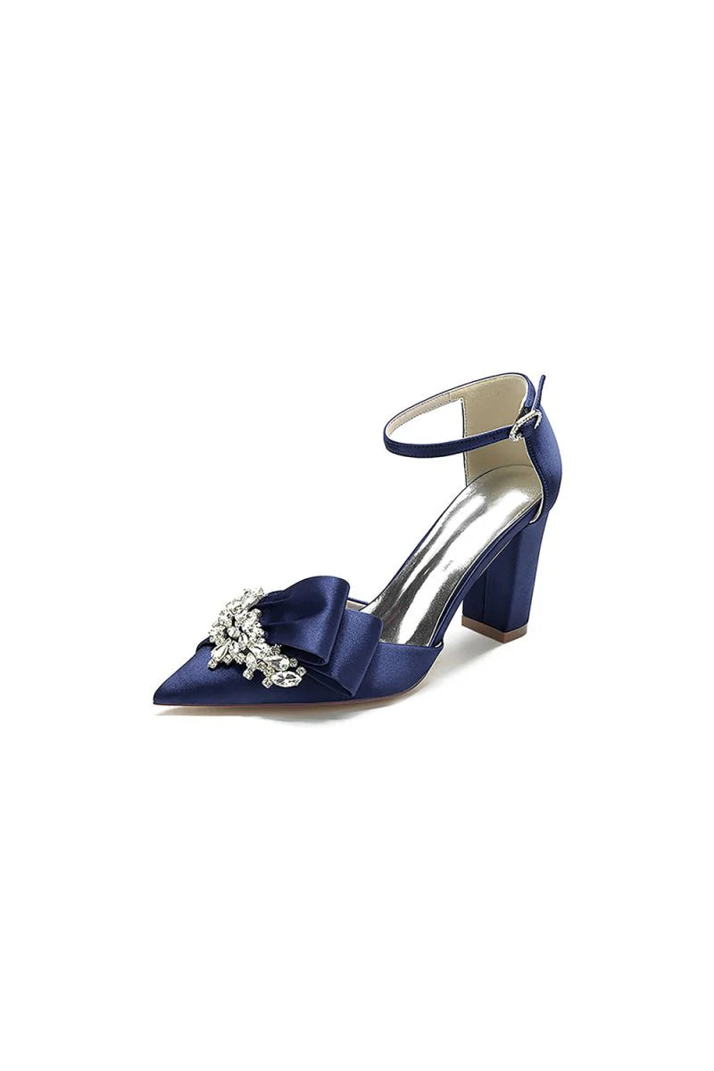 White Satin Heels Featuring a Large Decorative Bow and Metallic Heel