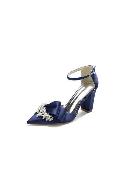 White Satin Heels Featuring a Large Decorative Bow and Metallic Heel